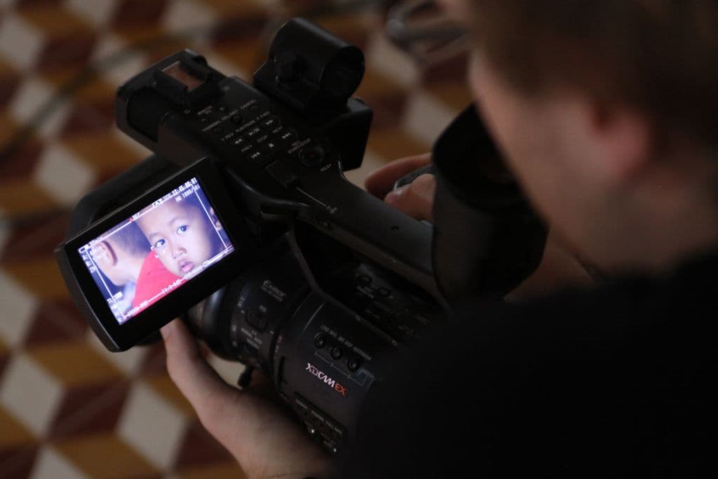 Sihanoukville, Cambodia :: Doulos videographer Adam Natrop (USA) films a child.